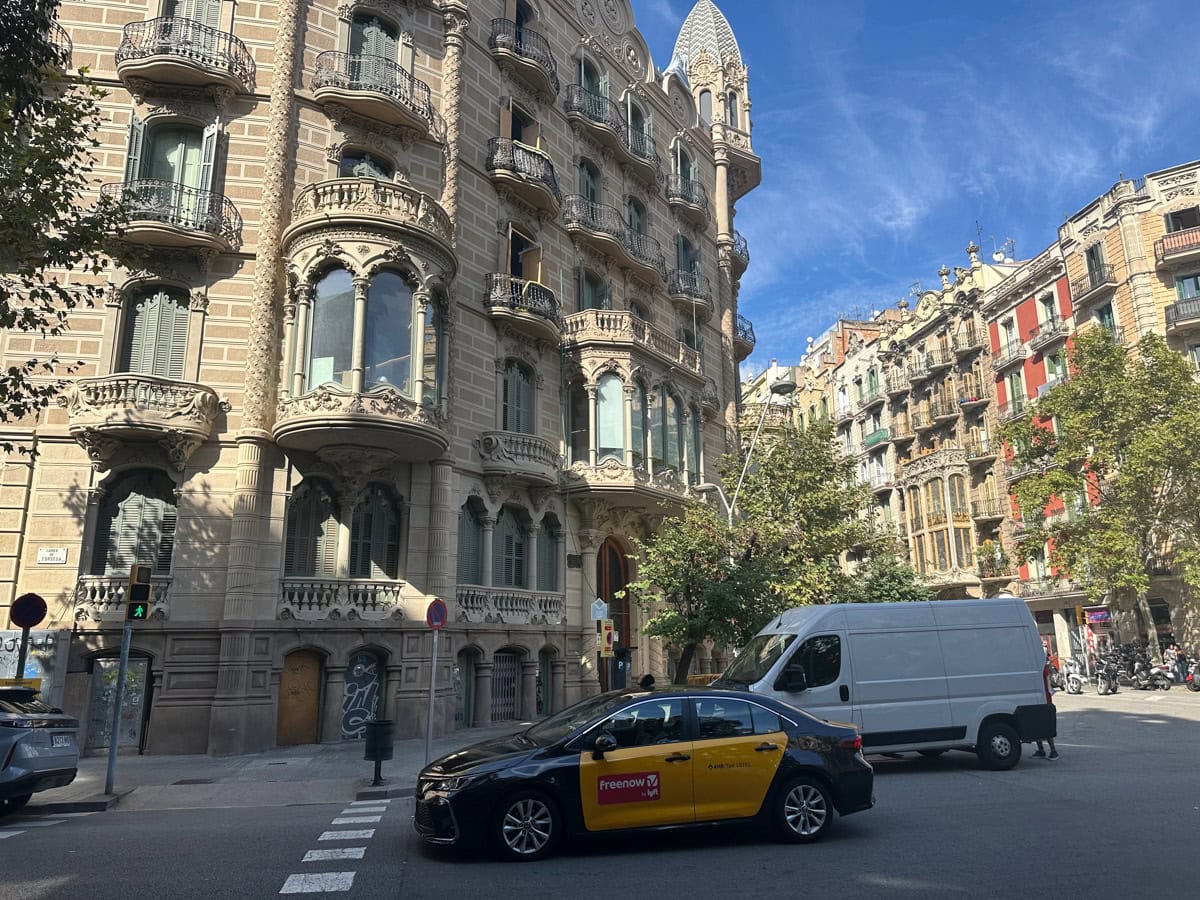 Buildings and cars passing in Barcelona, Spain.