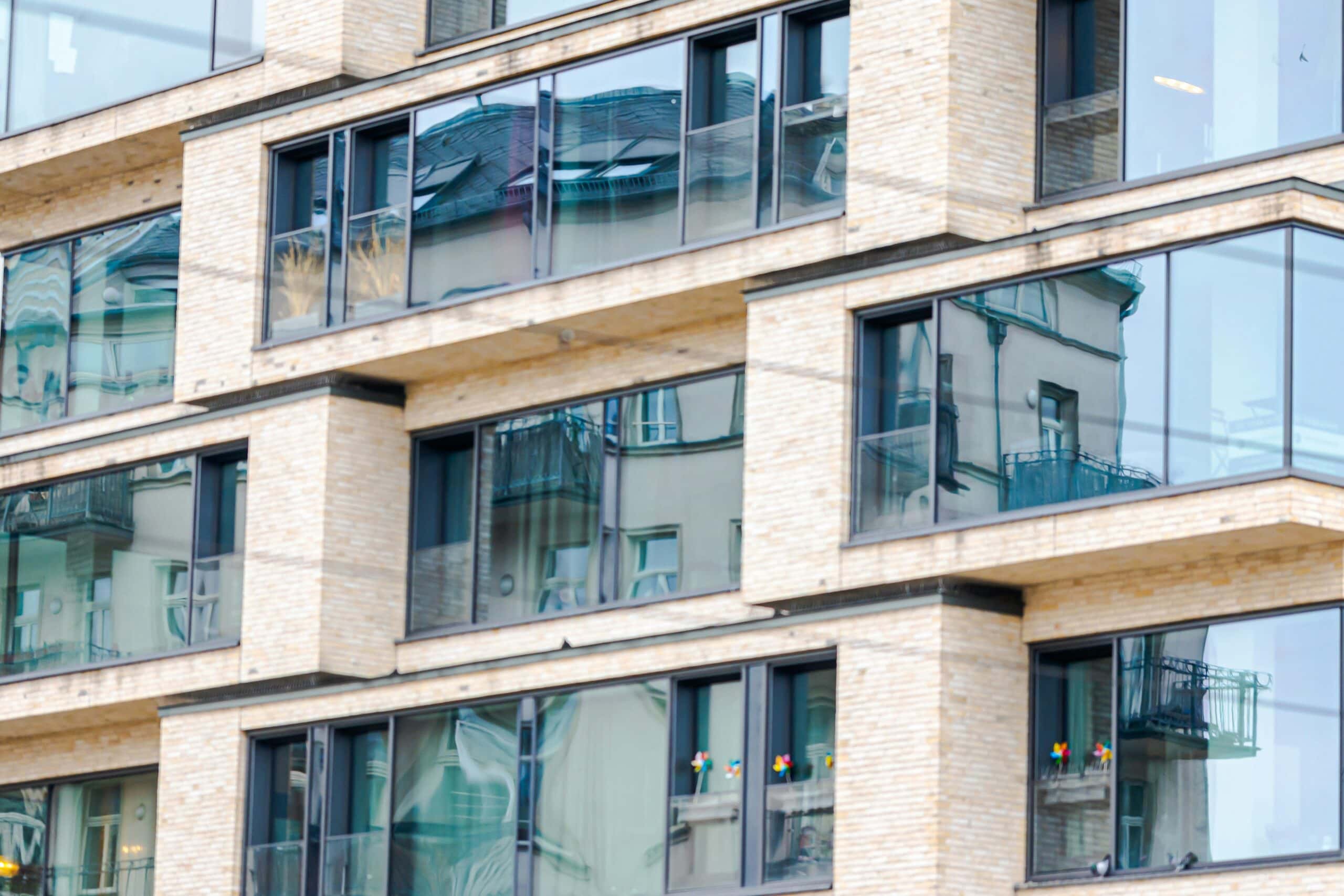 Part of a building of modern flats with glass windows in Germany