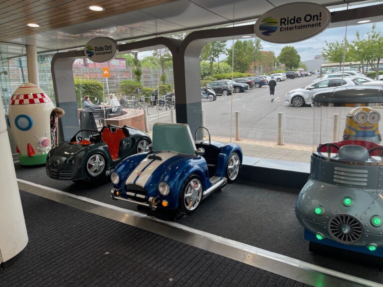 Photo of a row of shopping mall kids cars