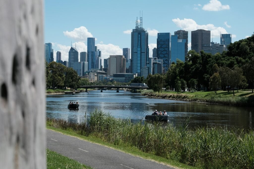 Skyline of high-rise buildings in Melbourne viewed from nearby park
