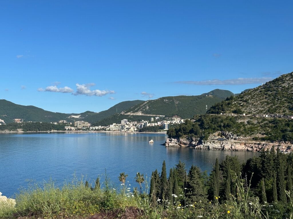 View of the coastline near Budva, Montenegro with coastal town in the distance and mountainous area further inland