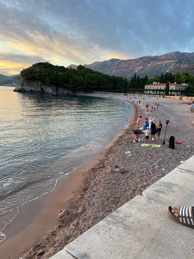 Beach in late afternoon, with mountains in the background in Montenegro