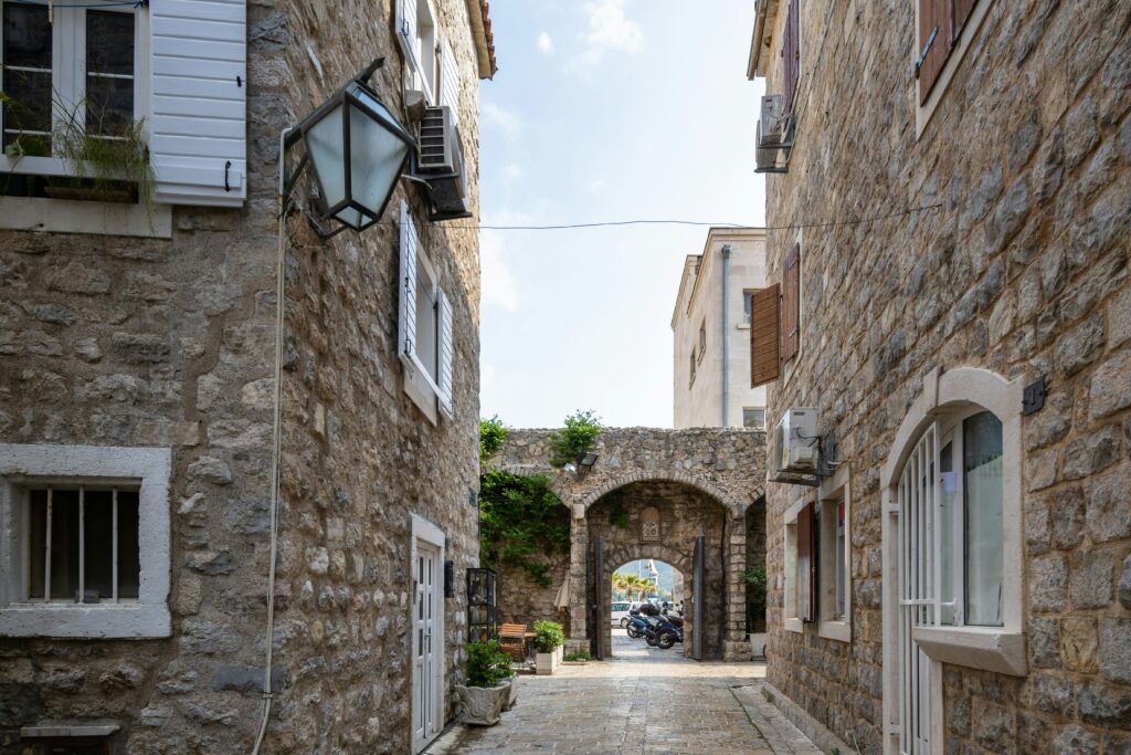 Narrow street lined with stone houses in the old town of Budva, Montenegro