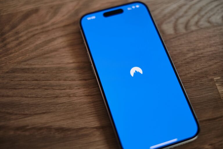 A touchscreen phone with blue screen and a logo of a mountain.