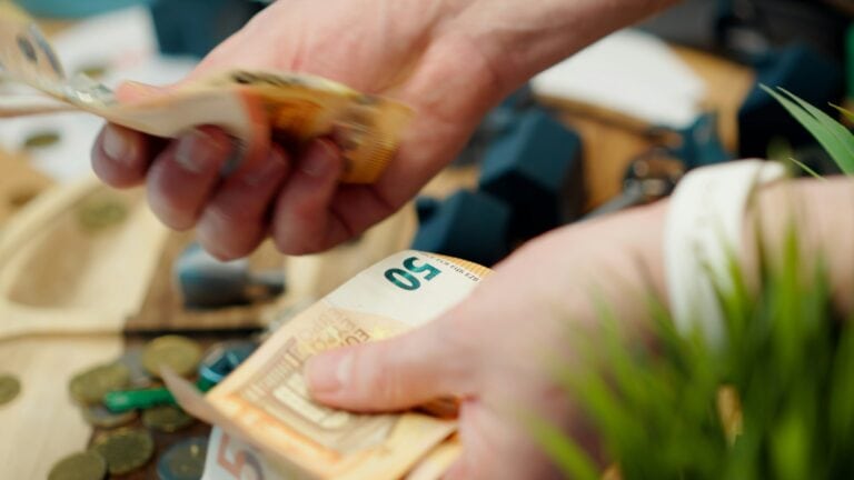 Close-up of hands counting euro bills of 50 euros