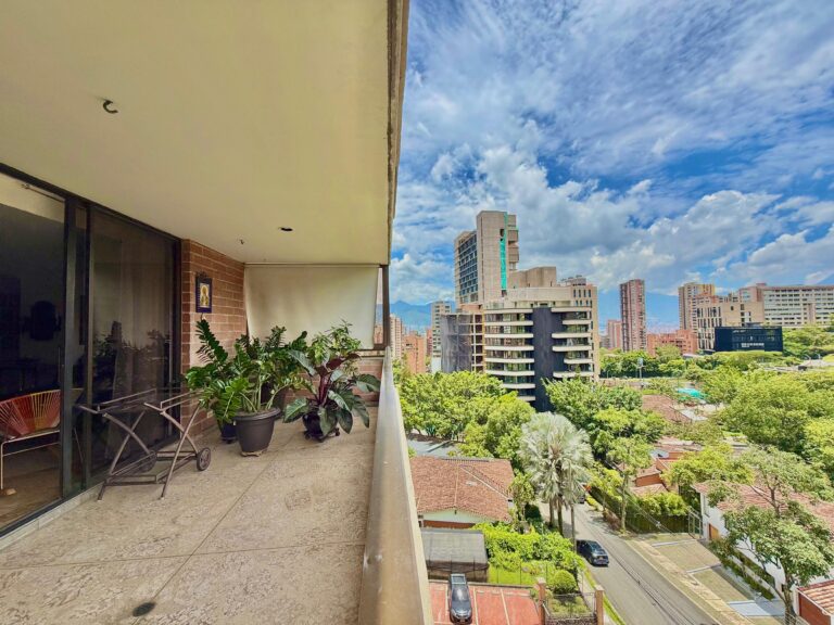 View from a large balcony on a residential area in Medellin with blocks of flats and streets lined with trees