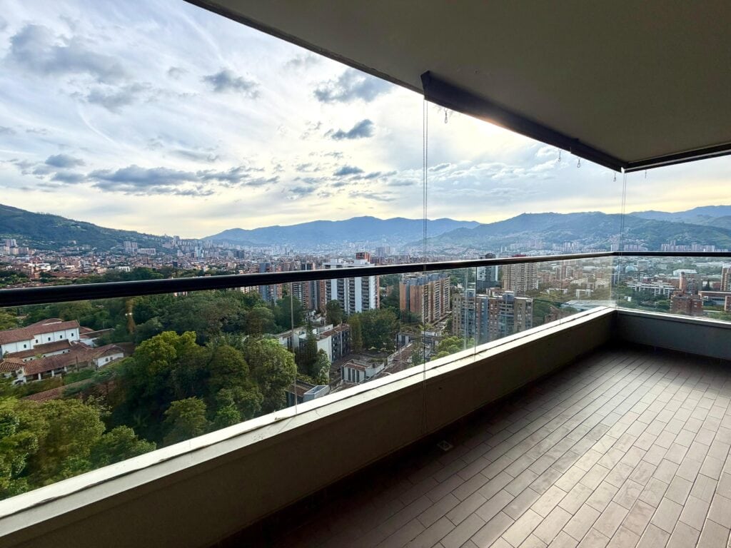 View from a large balcony on a residential area in Medellin with mountainous area behind it
