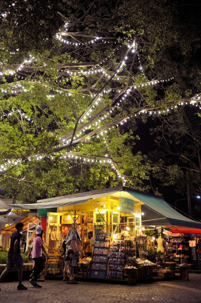 Small shop for tourists selling small items, lit up at night, in Chiang Mai
