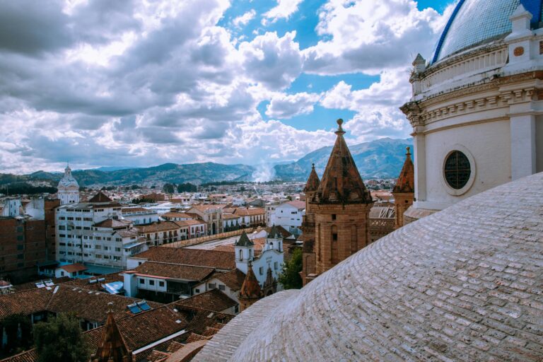 View of the city of Cuenca, Ecuador from on top of one of the cathedrals, seeing mountains in the distance